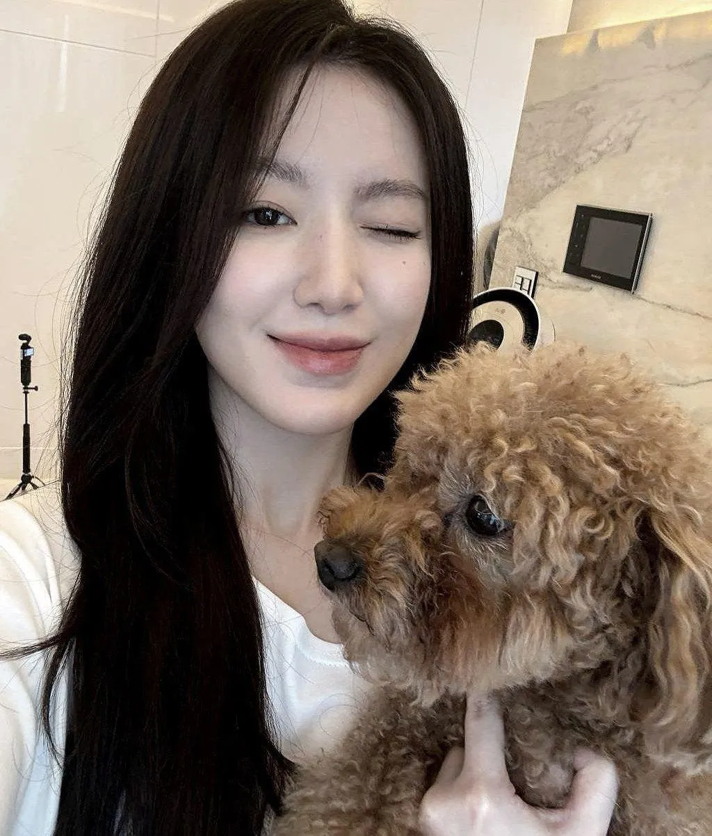 Smiling Woman Holding Fluffy Dog in a Cozy Home Interior