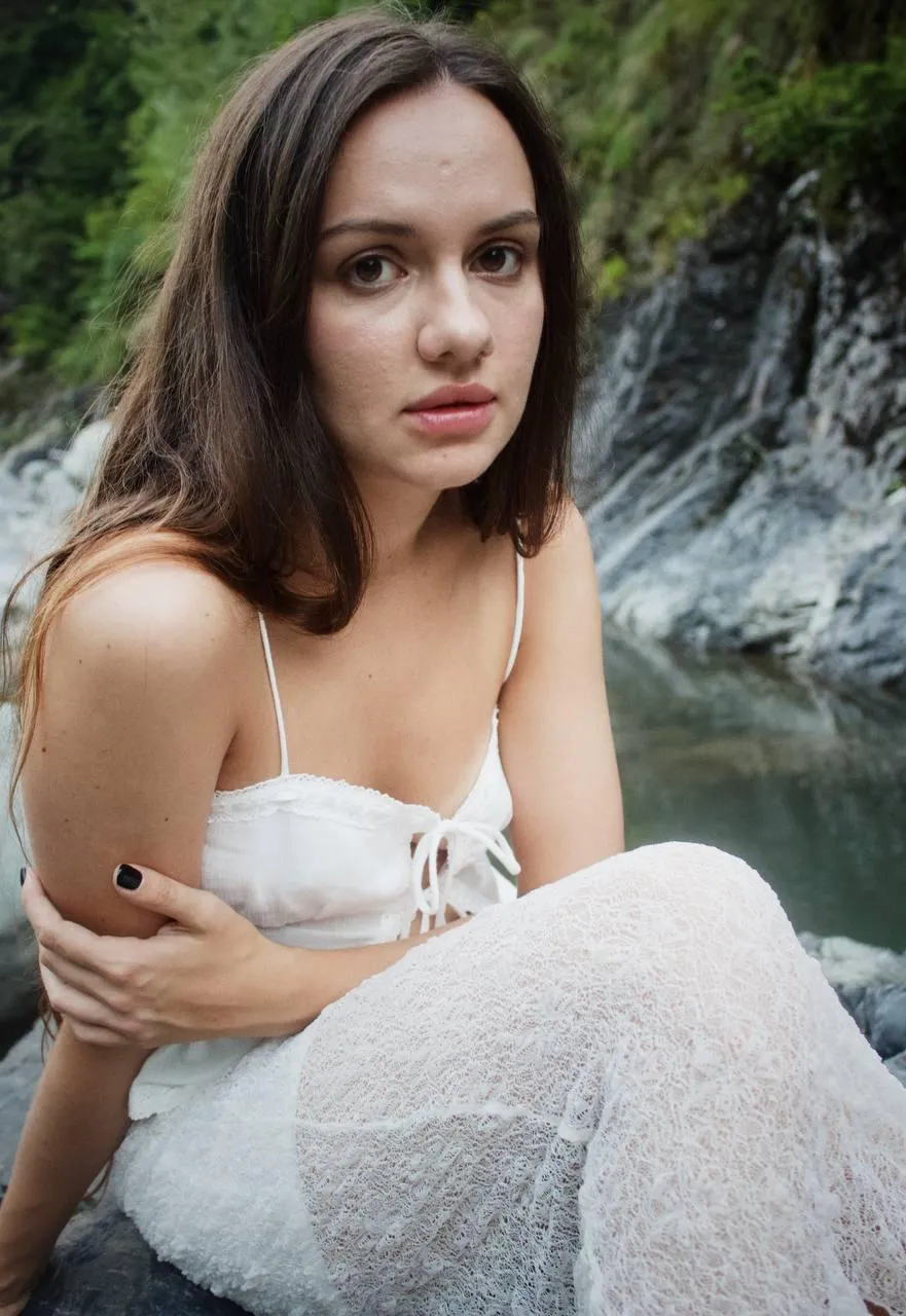 Soft Natural Light Portrait with a Woman Sitting Near Water