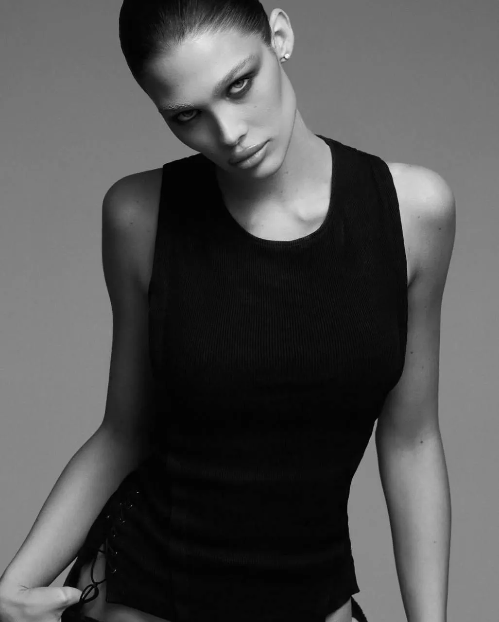 Strong elegant woman in a sleeveless black dress wallpaper