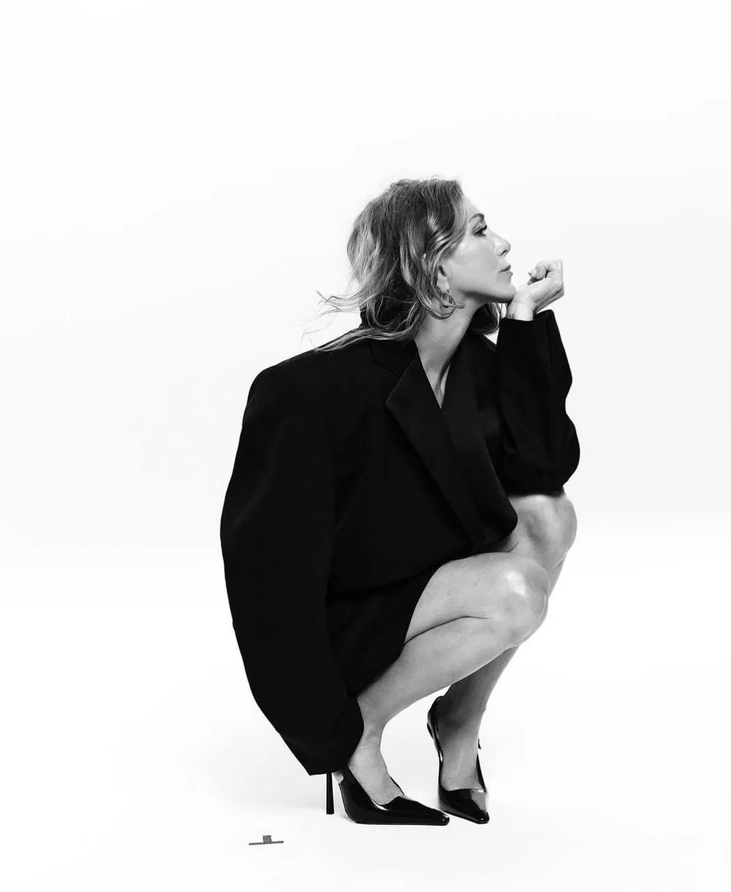 Stunning image of a woman squatting on the studio floor