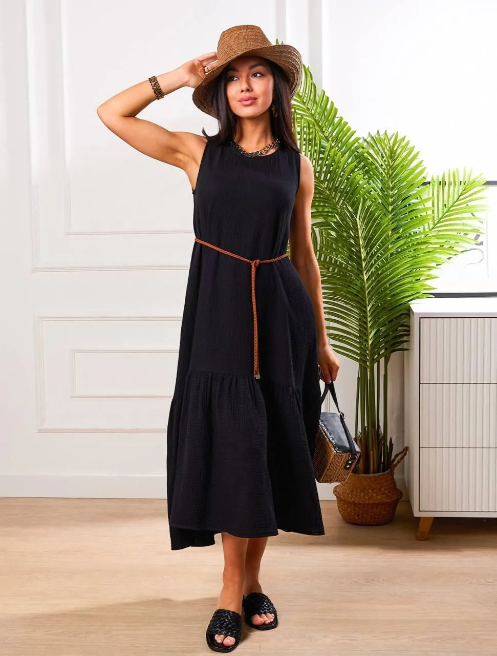 Stylish Woman in a Black Dress And Hat Walking Indoors Image
