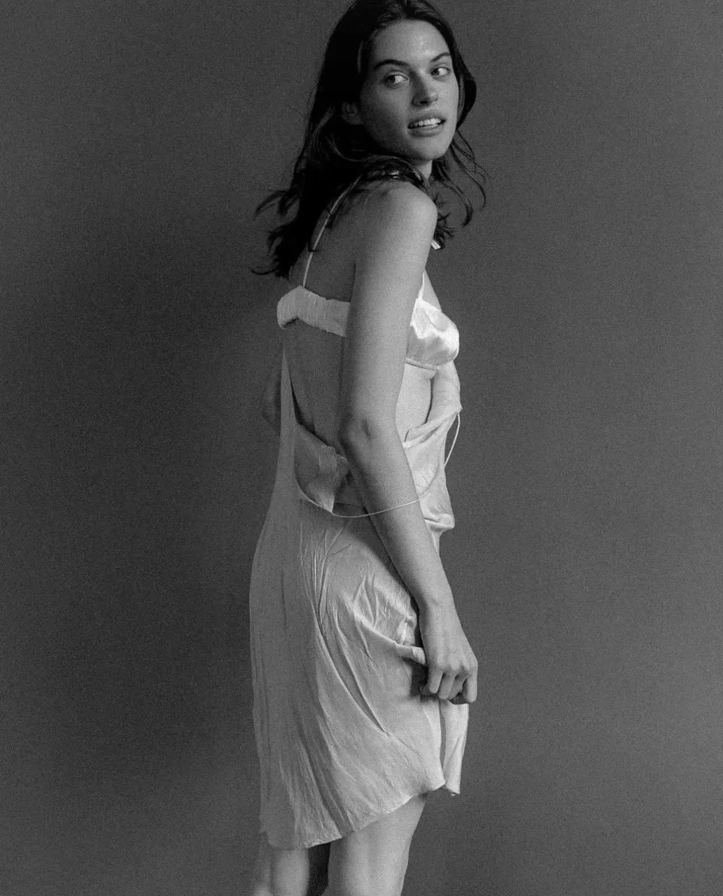 Stylish Woman in a Dress Standing in Black And White Image