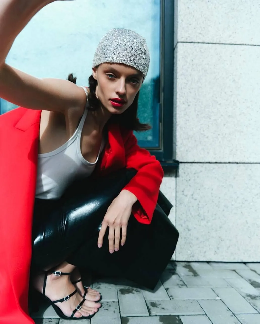 Stylish Woman in a Red Blazer And a Beanie Posing Outside