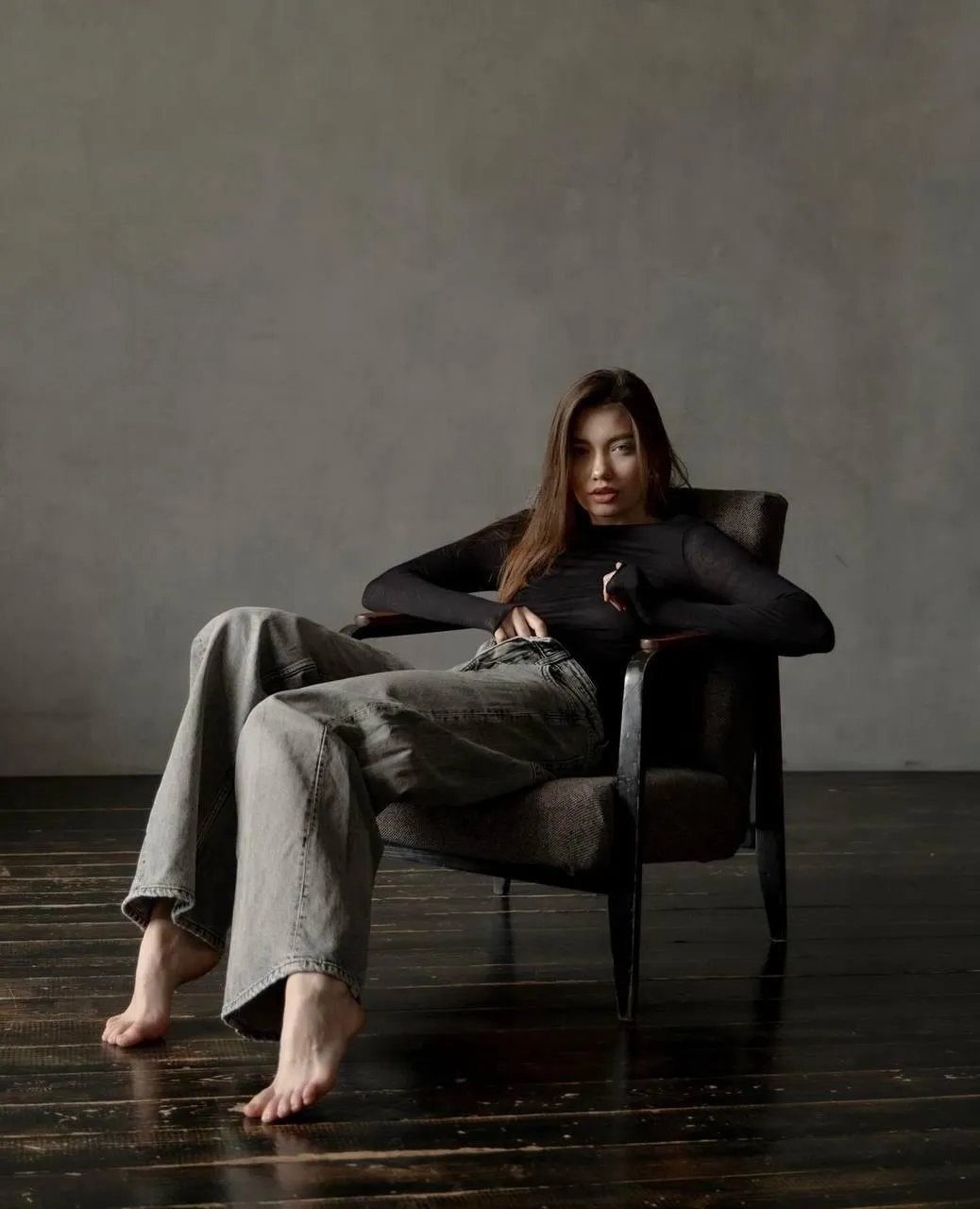 Stylish woman in a suit relaxing in a minimal modern space