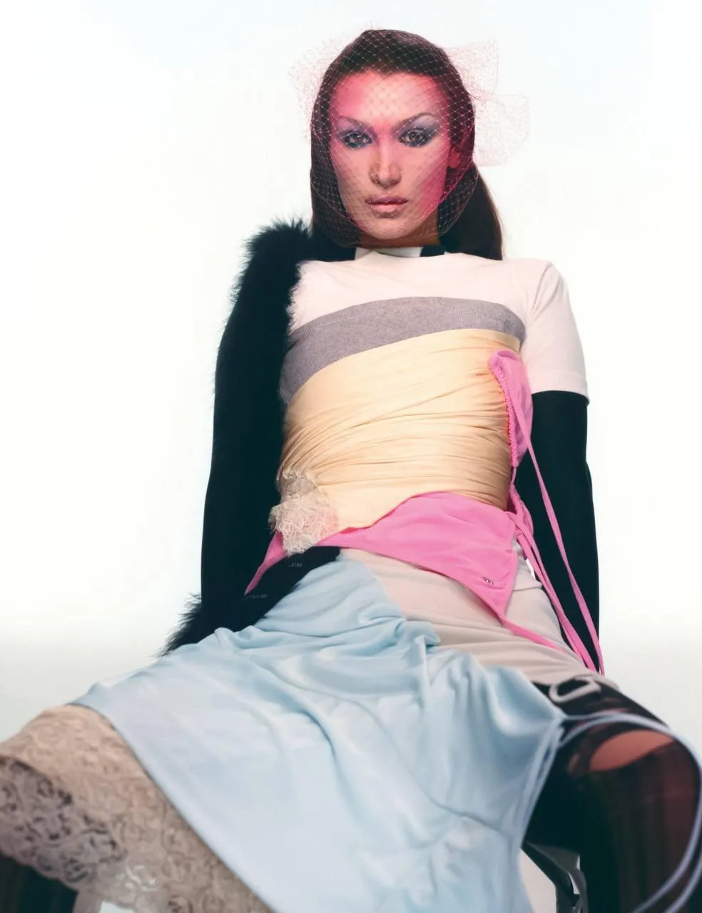 Stylish woman in layered fashion posing on white background