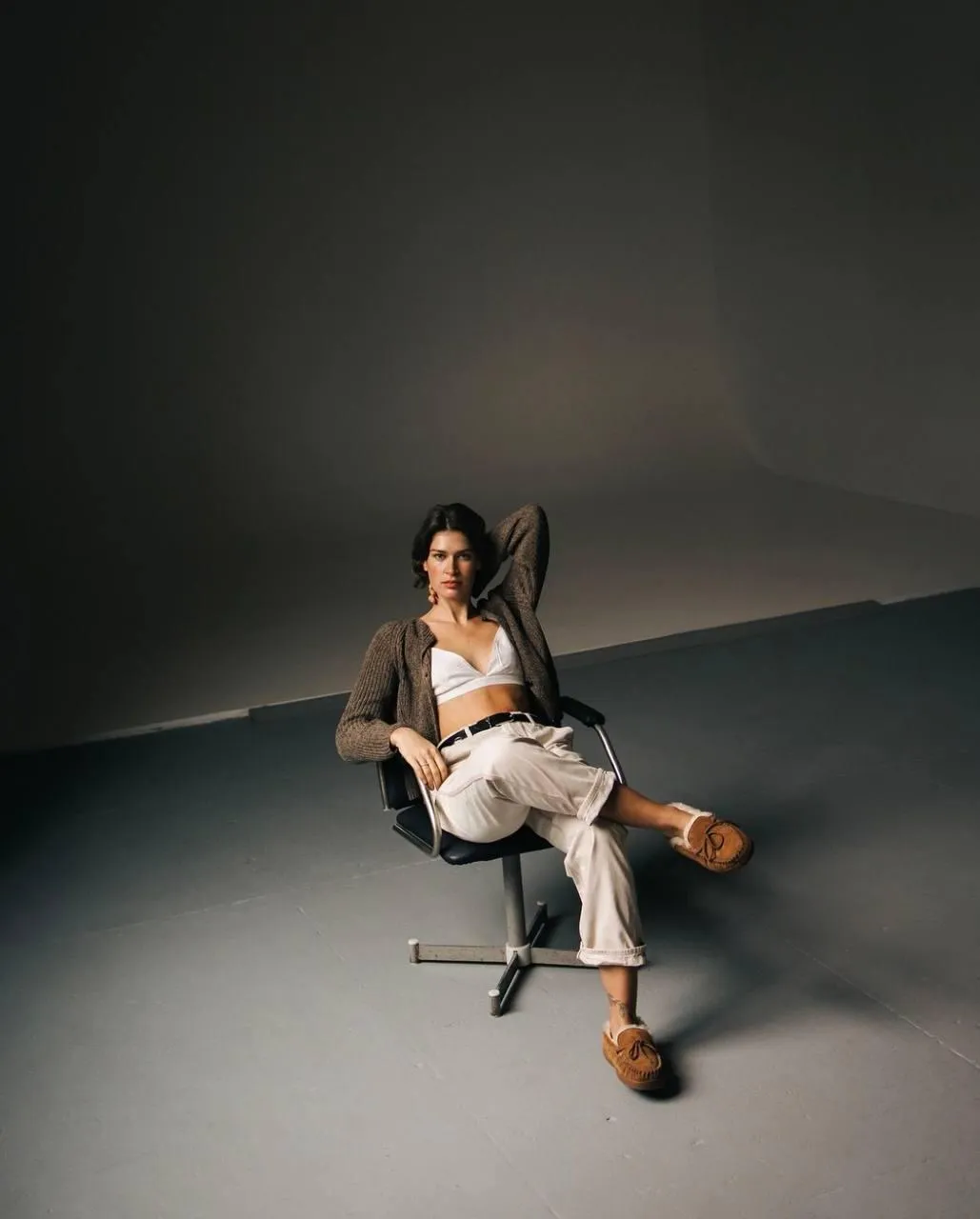 Stylish woman sitting in a chair with a confident expression