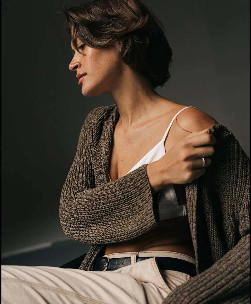 Thoughtful Woman Wearing a Cardigan in Warm Natural Lighting