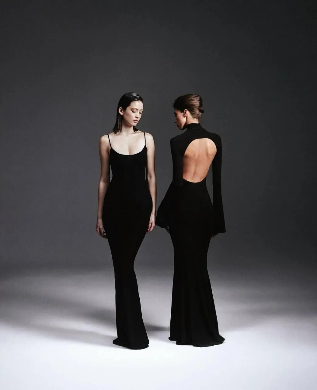 Two fashionable women dressed in matching black style image
