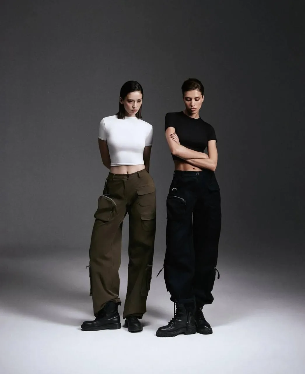 Two stylish women posing together in a modern fashion photo