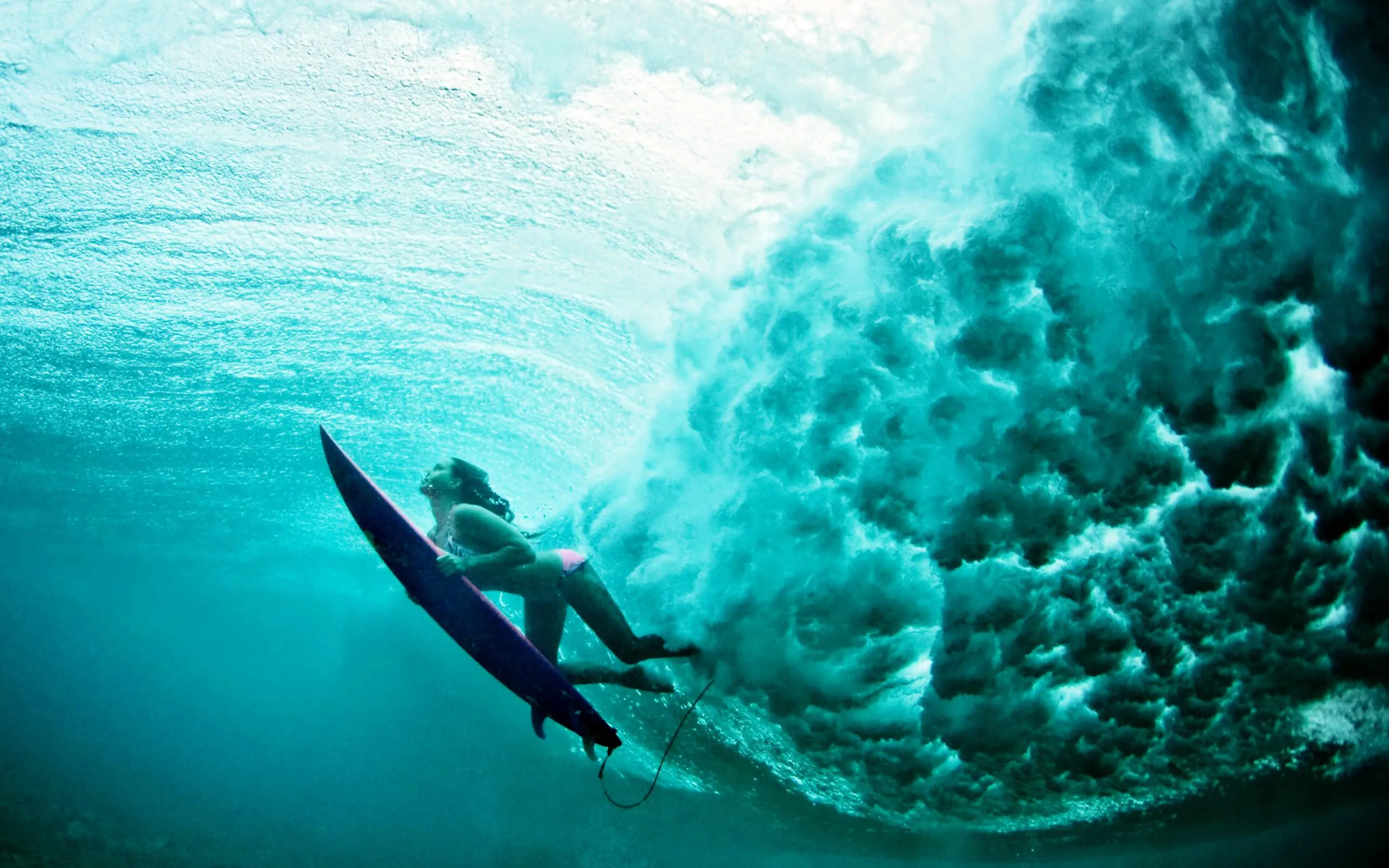Underwater Surfer Gliding Below a Curling Blue Wave Image