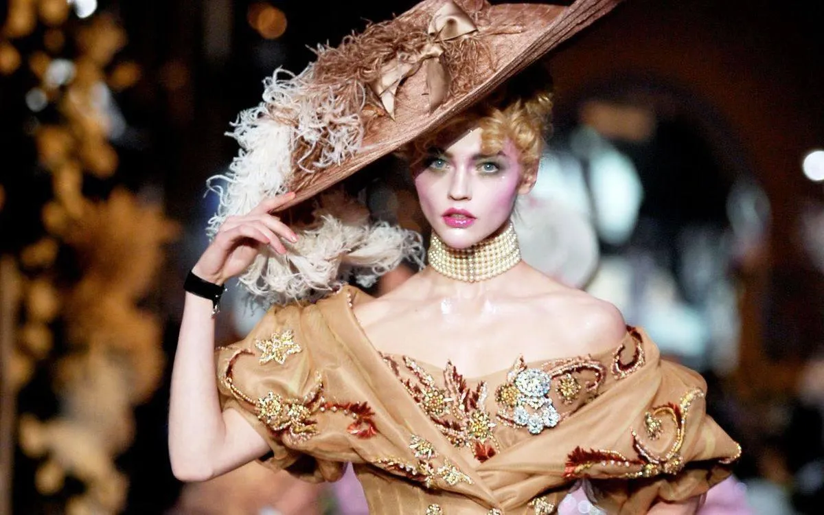Vintage Styled Woman in an Ornate Hat on Fashion Runway