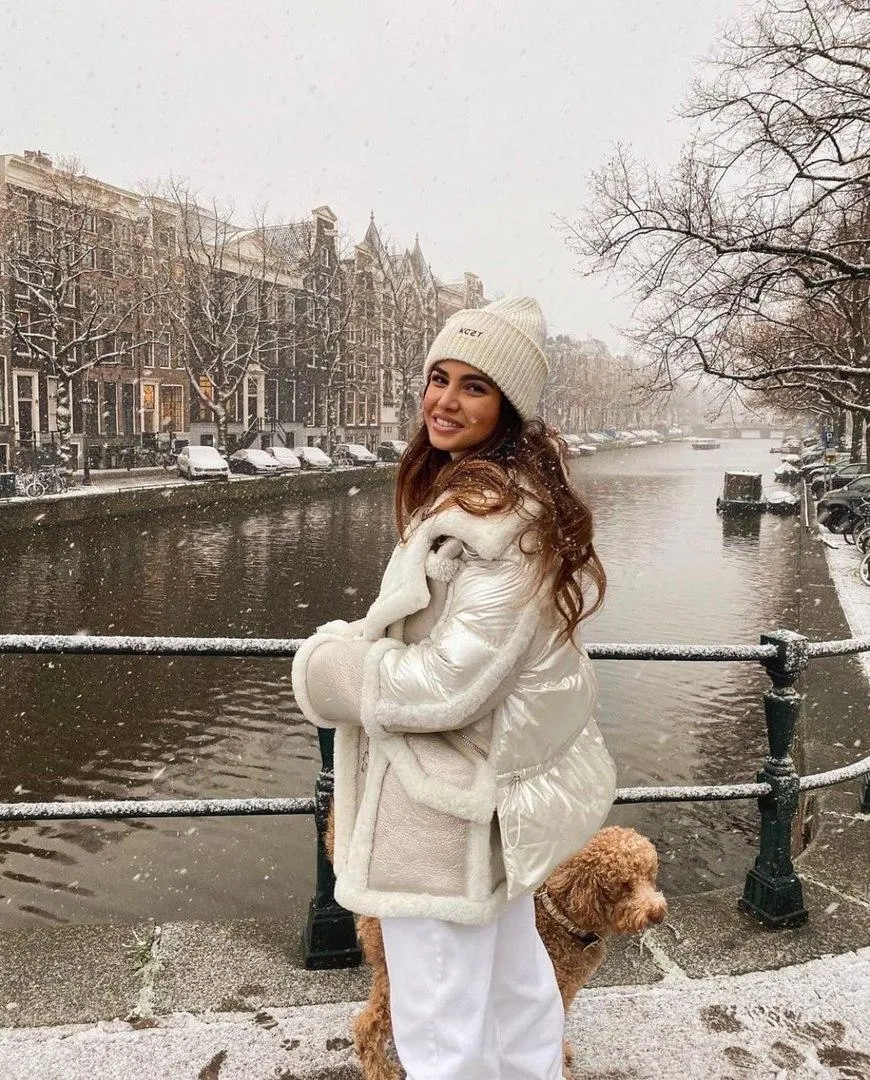 Winter Fashion Shoot with Woman And a Dog Near a Snowy Canal