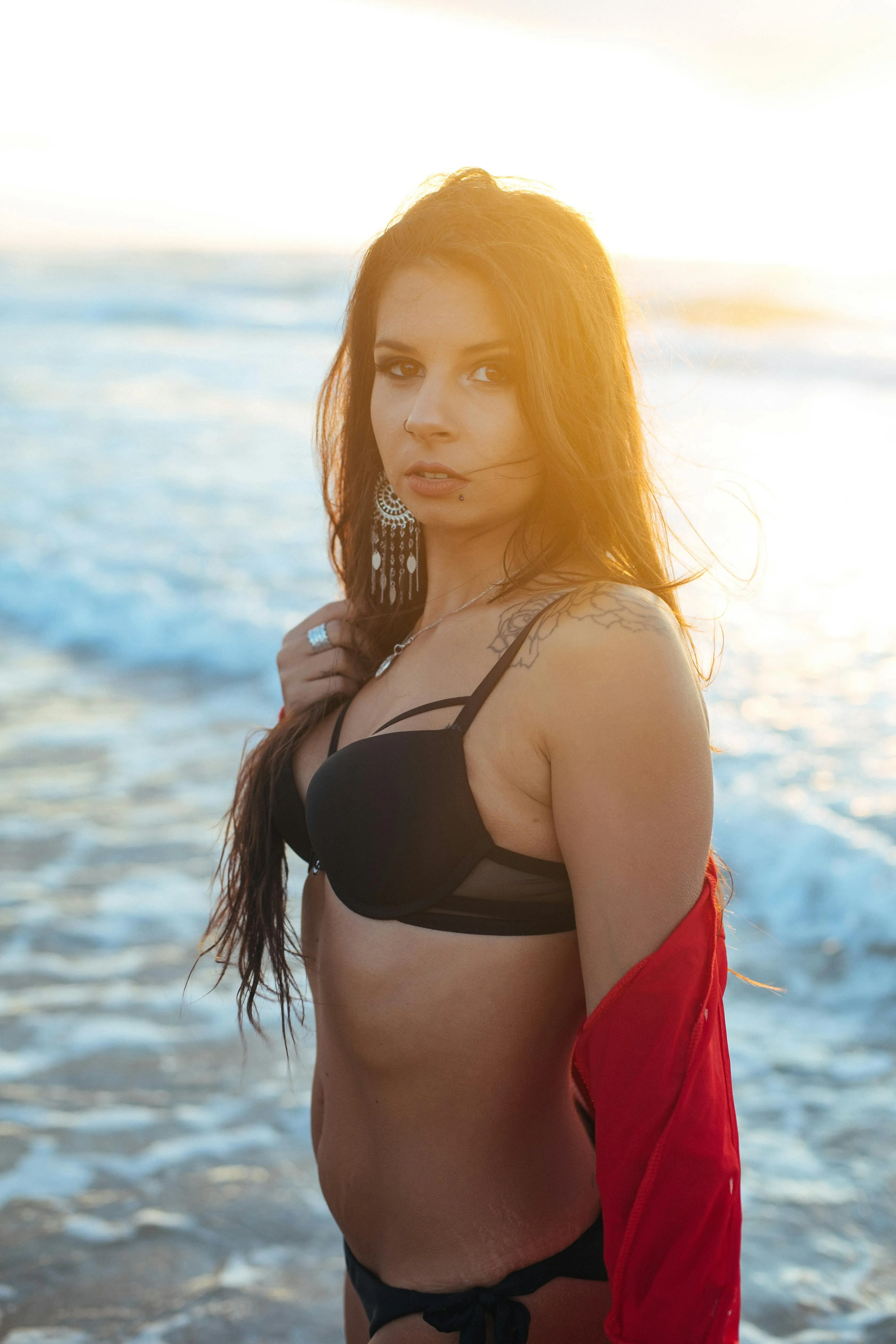 Woman at the Beach Looking Over Her Shoulder with a Towel