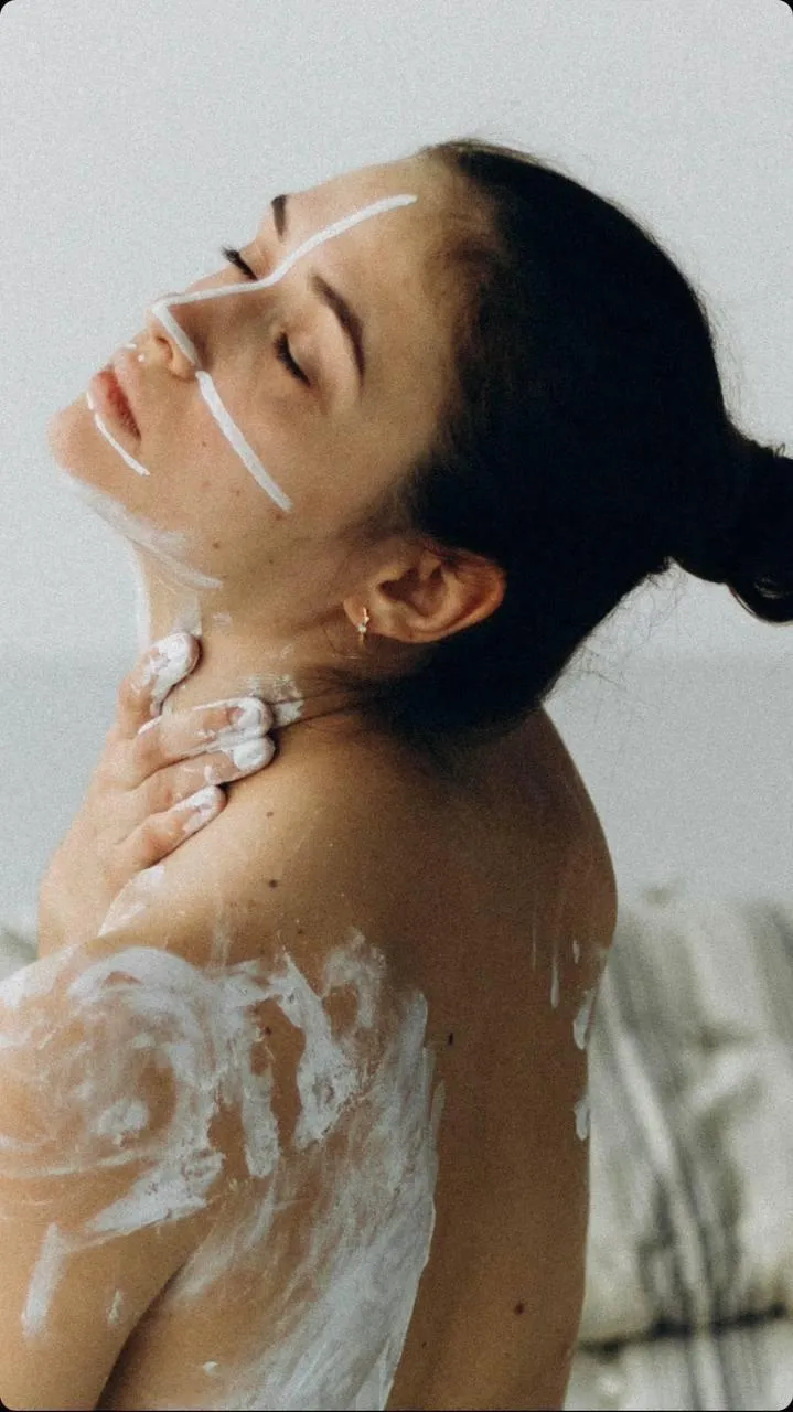 Woman Enjoying a Milk Bath with Head Tilted And Eyes Closed