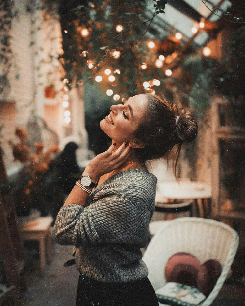 Woman Enjoying the Ambiance in a Cozy Warmly Lit Cafe Image