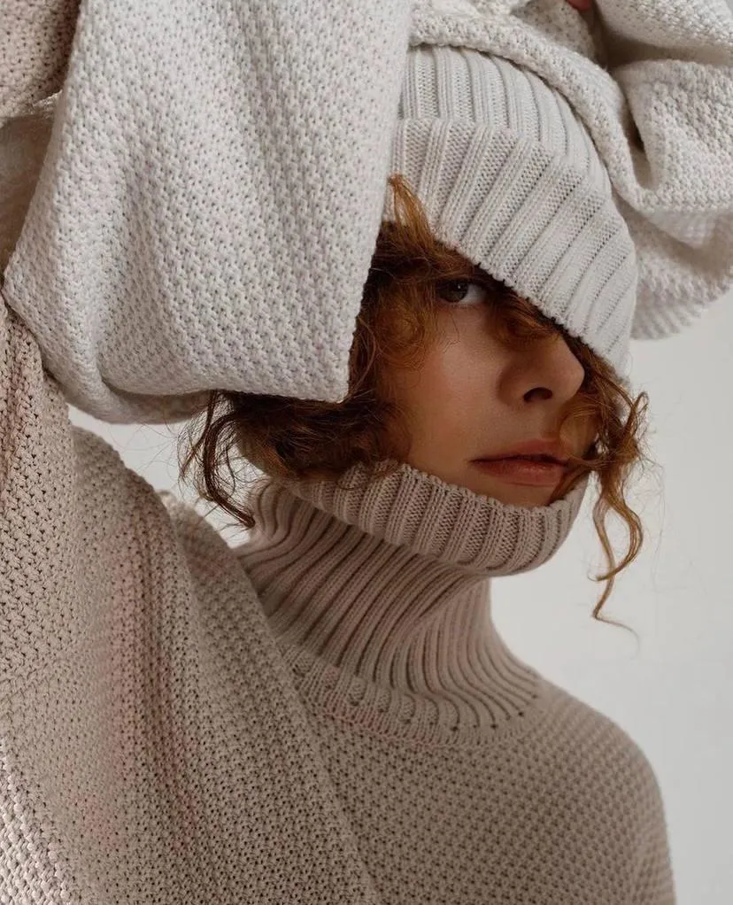 Woman Hiding Face in an Oversized Sweater with Curly Hair