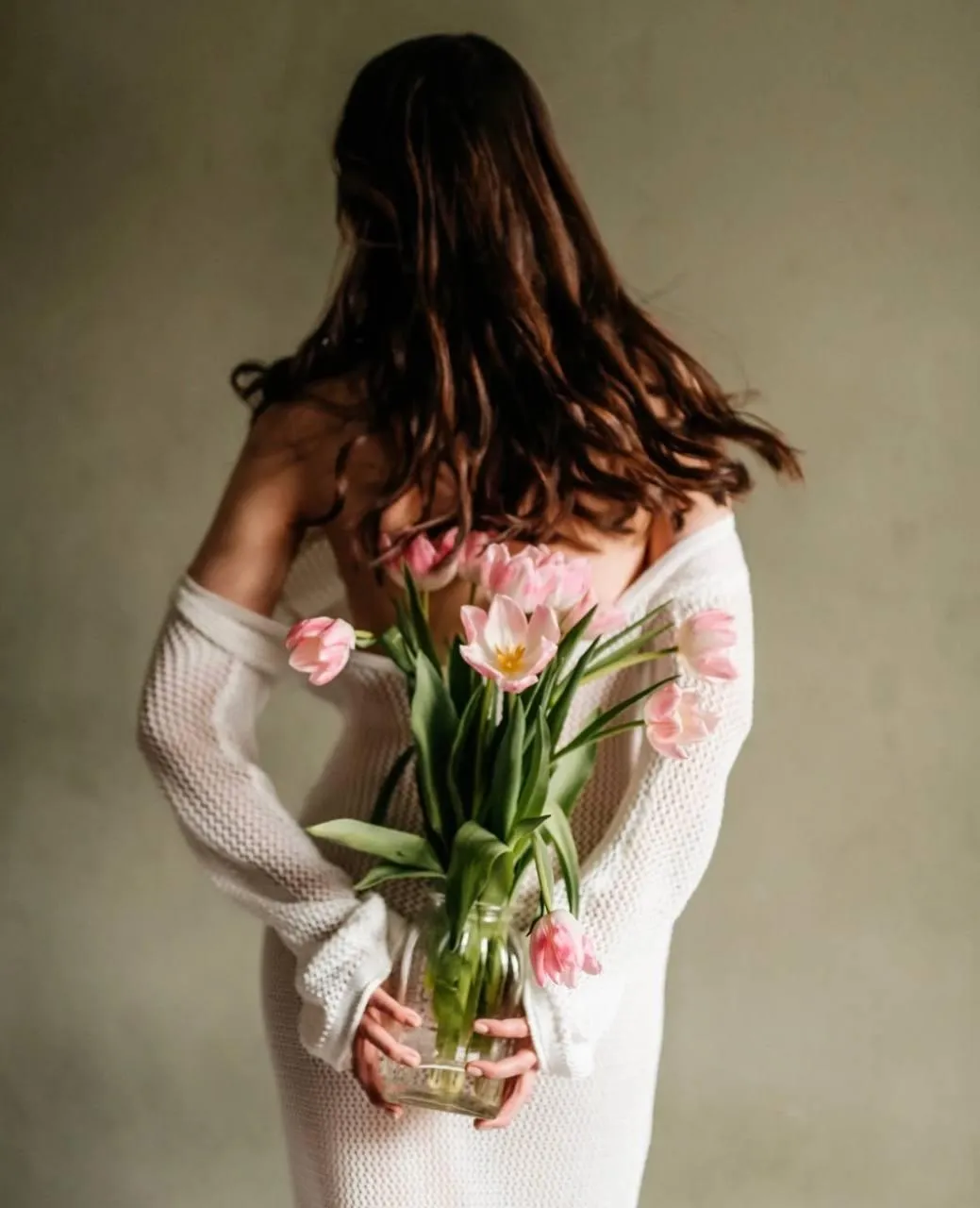 Woman holding a bouquet of tulips behind her back Wallpaper
