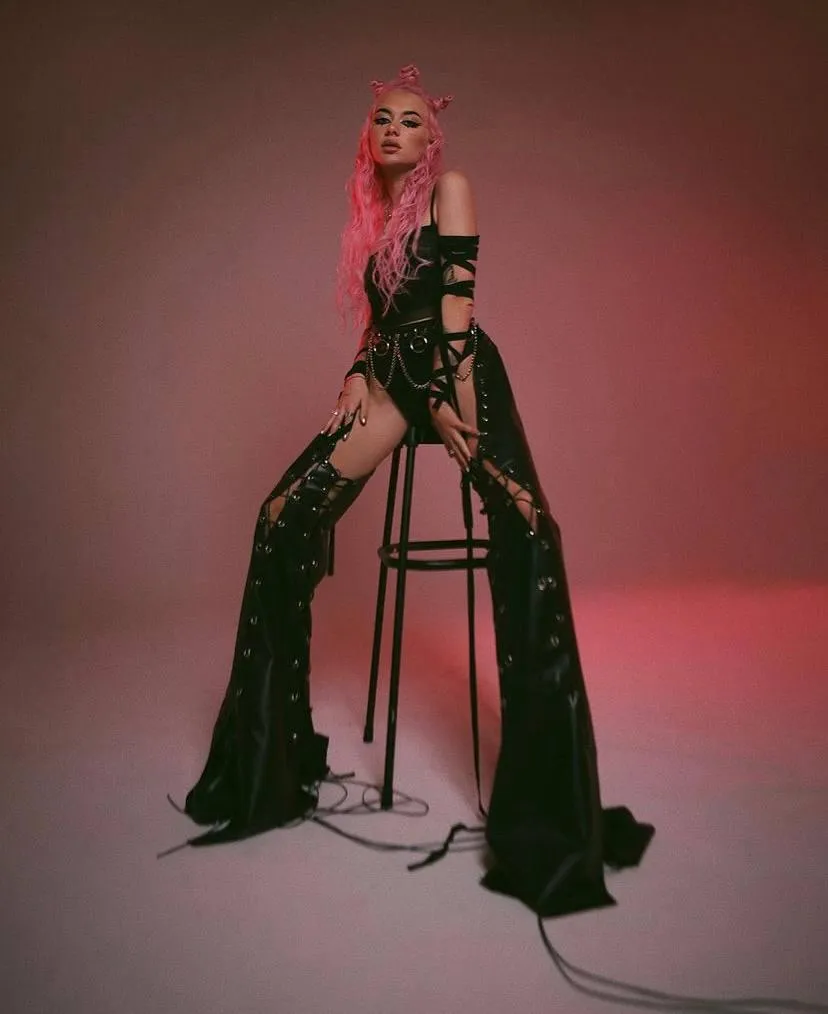 Woman in a bold green outfit posing with confident style