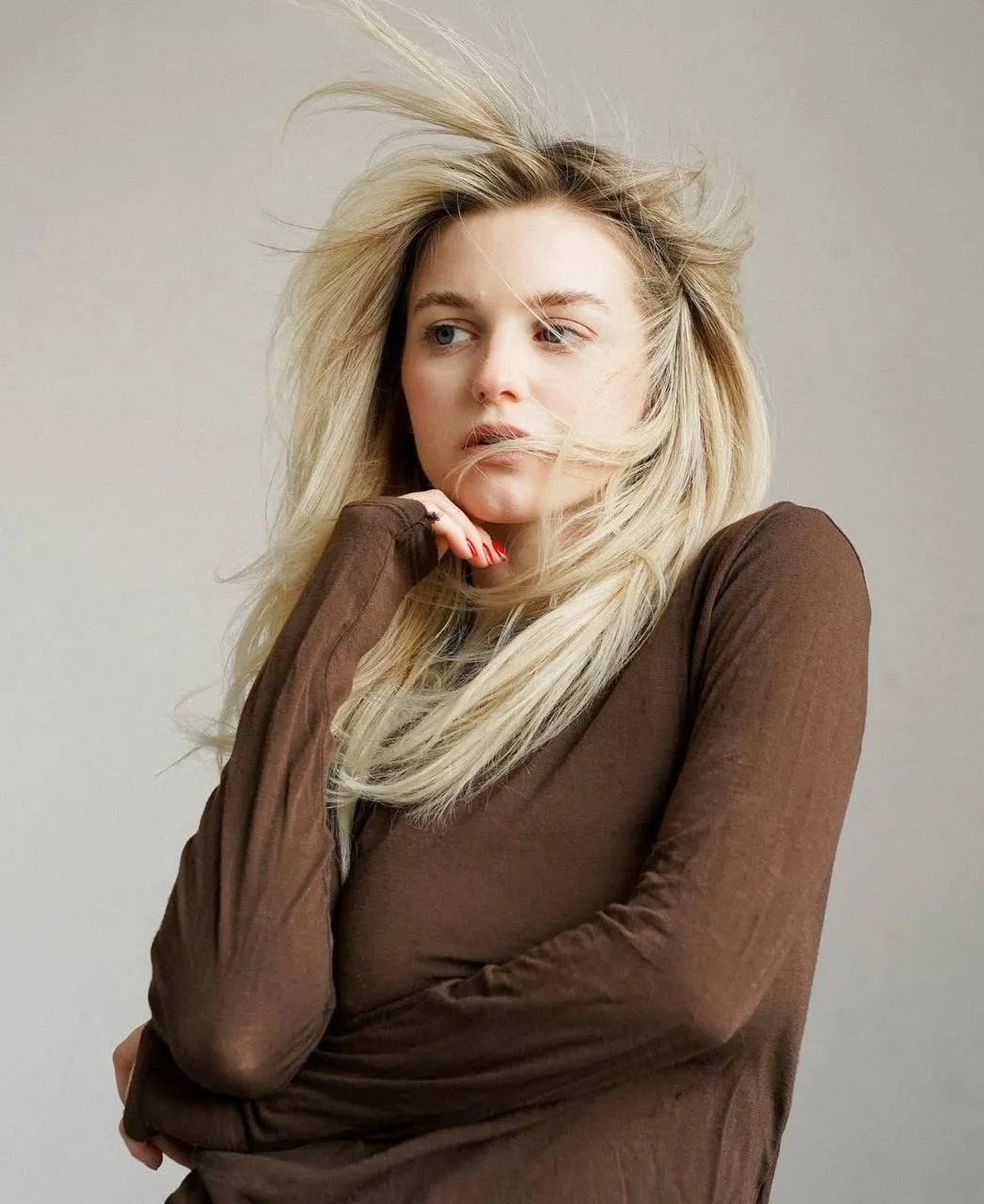 Woman in a Cozy Winter Outfit Looking Off in Deep Thought