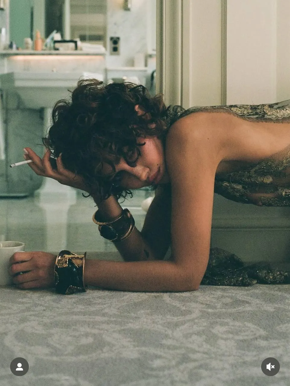 Woman in a Dark Dress Lying Down on Floor in Moody Lighting