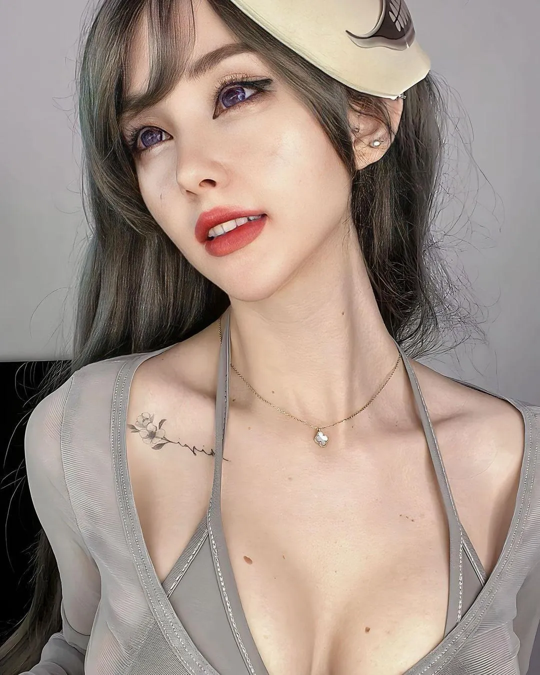 Woman in a Grey Top with a Hat Poses in Soft Dramatic Light