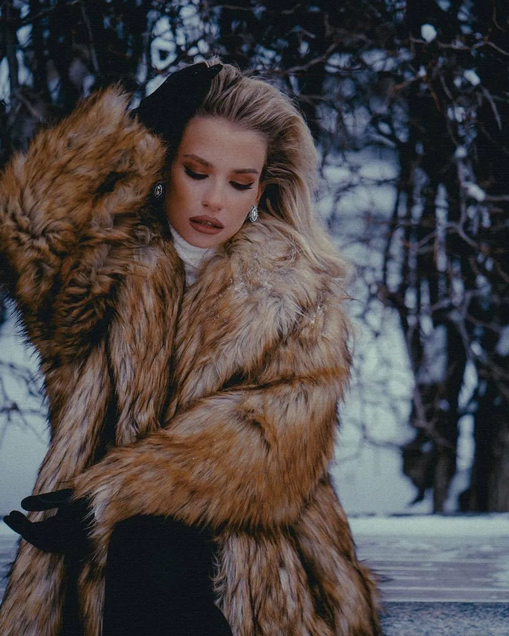 Woman in a Heavy Fur Coat Poses Outside in Winter Light