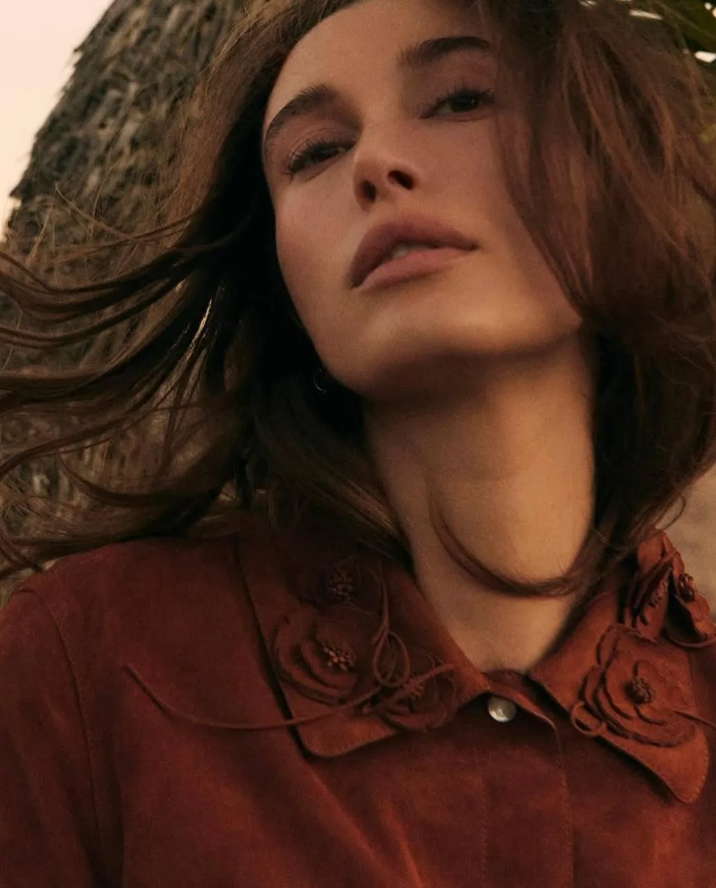 Woman in a Rust Blouse Looking Confidently at the Camera