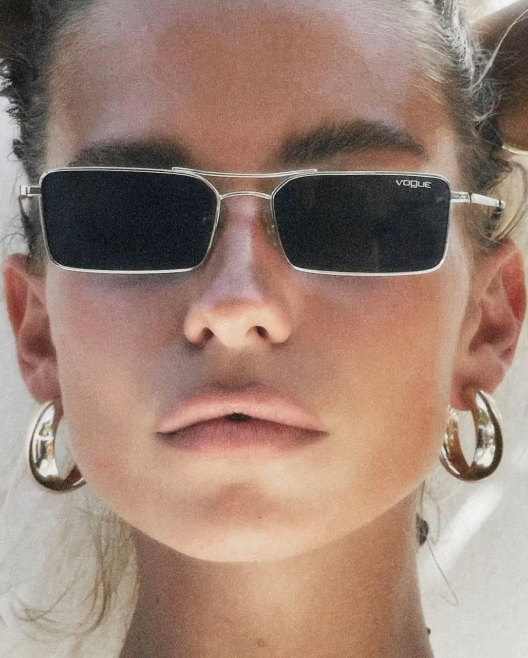 Woman in a Sunglasses And Earrings Under Bright Sunlight