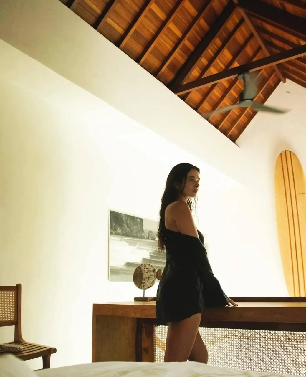 Woman in a Swimsuit Walking Inside a Minimalist Modern Space