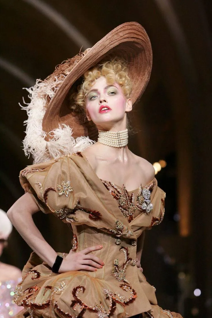 Woman in a Vintage Dress And Hat Striking a Theatrical Pose