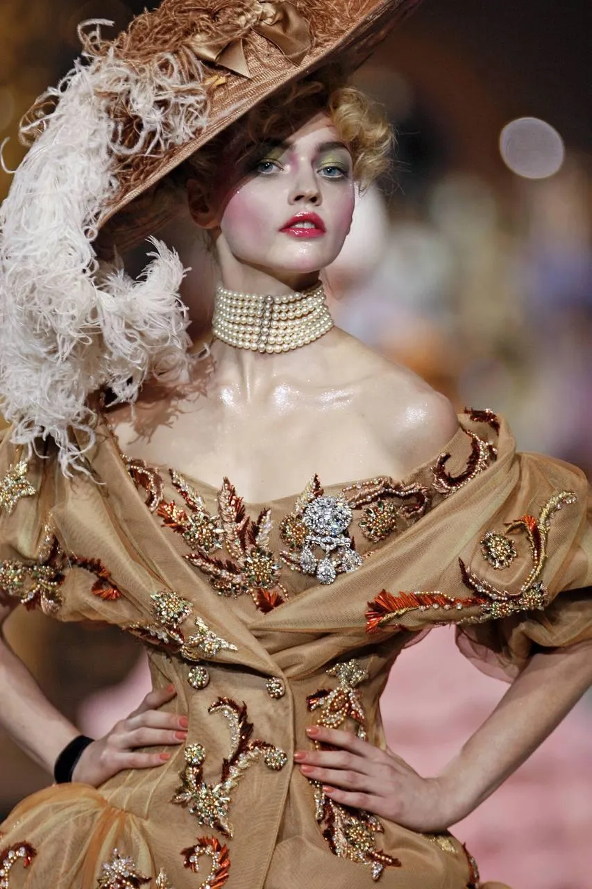 Woman in a Vintage Gown And a Large Hat on a Fashion Runway