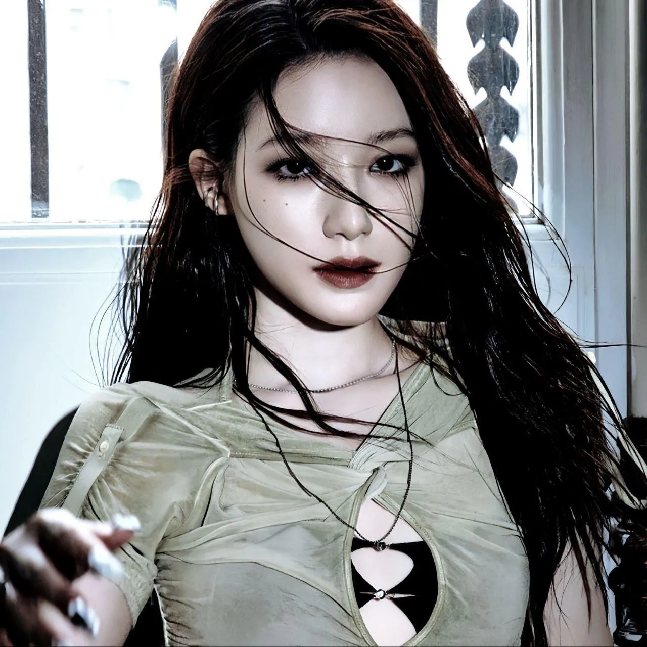 Woman in an Edgy Outfit Poses with Intense Bold Expression