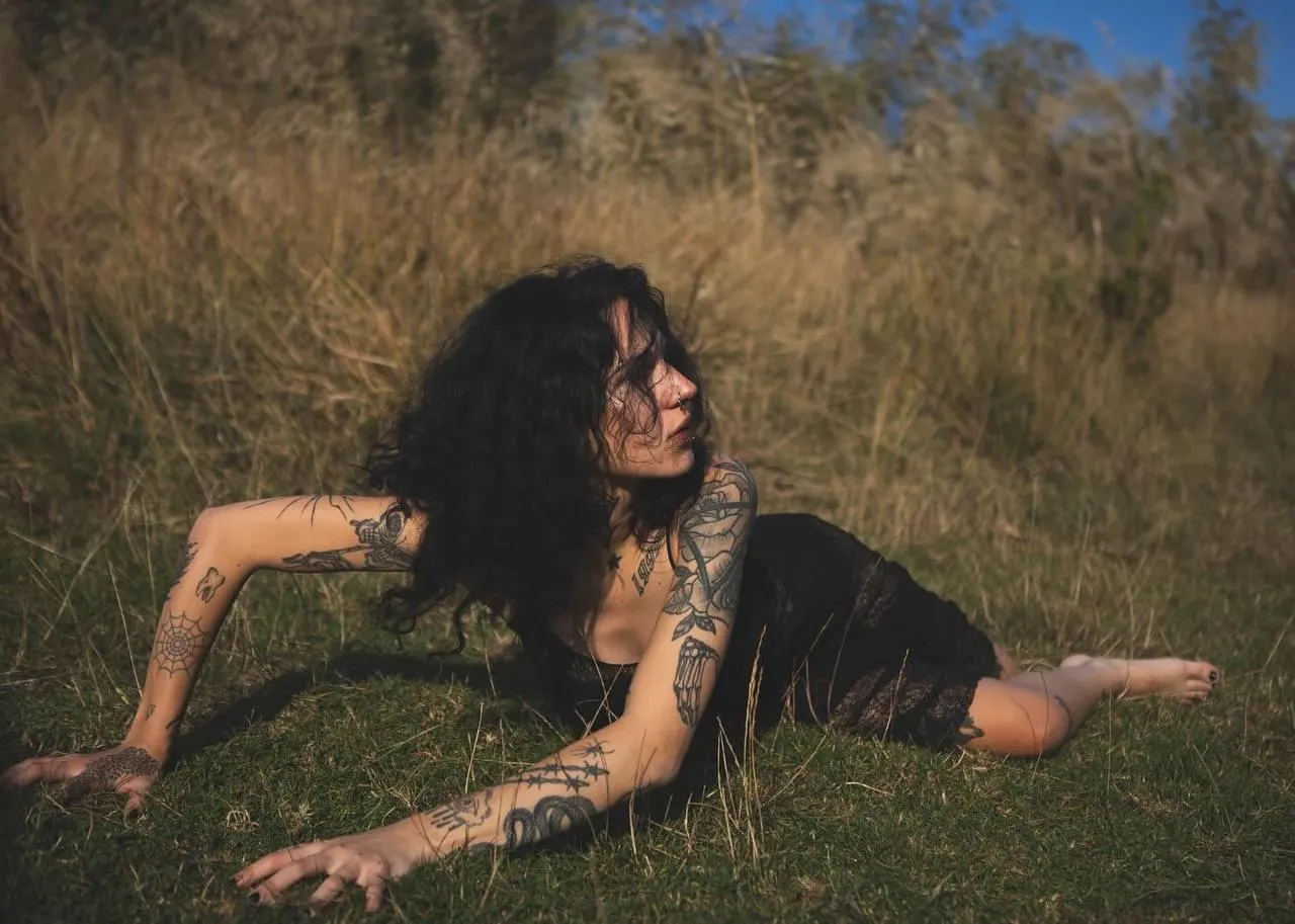 Woman in Black Crawling in a Field with Wild Natural Vibes