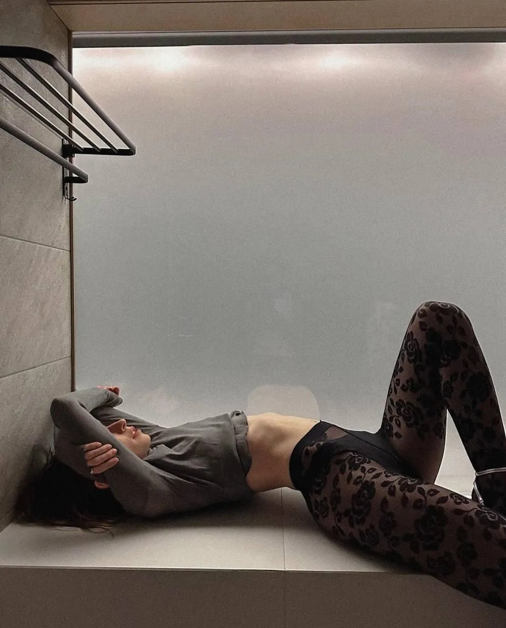Woman in Black Leggings And Sweater Lying Down on the Floor