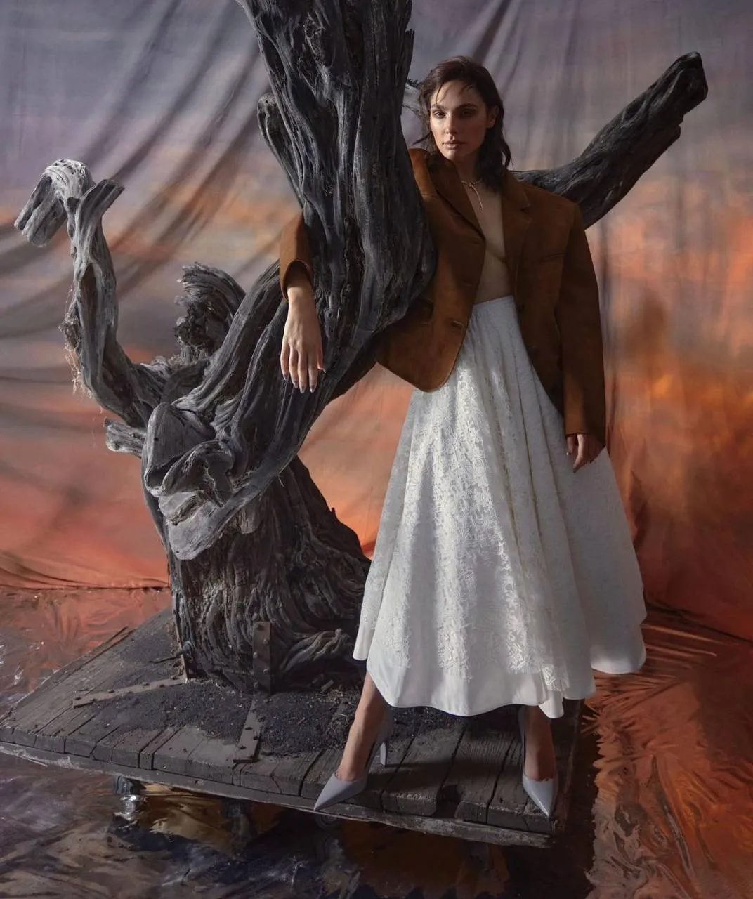 Woman in Brown Top And White Skirt Standing Near Sculpture