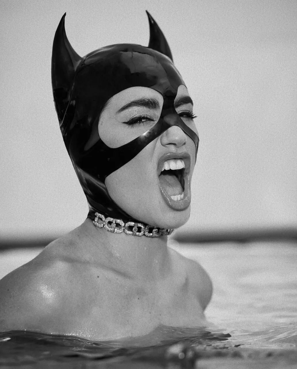 Woman in Cat Mask Screaming Playfully in the Water Wallpaper