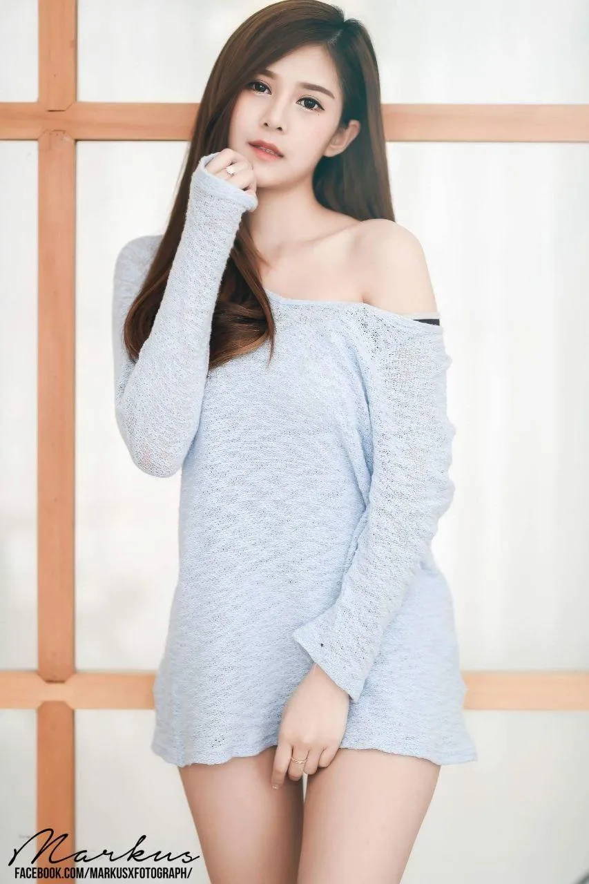 Woman in Cozy Off Shoulder Dress Posing in Soft Daylight