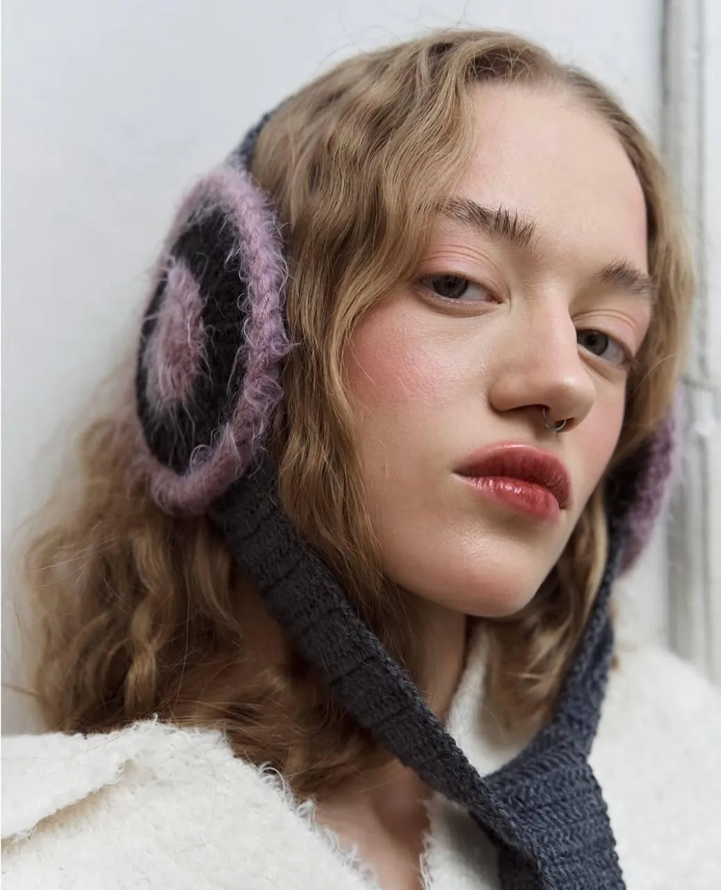 Woman in Earmuffs Wearing a Winter Coat And a Scarf Image