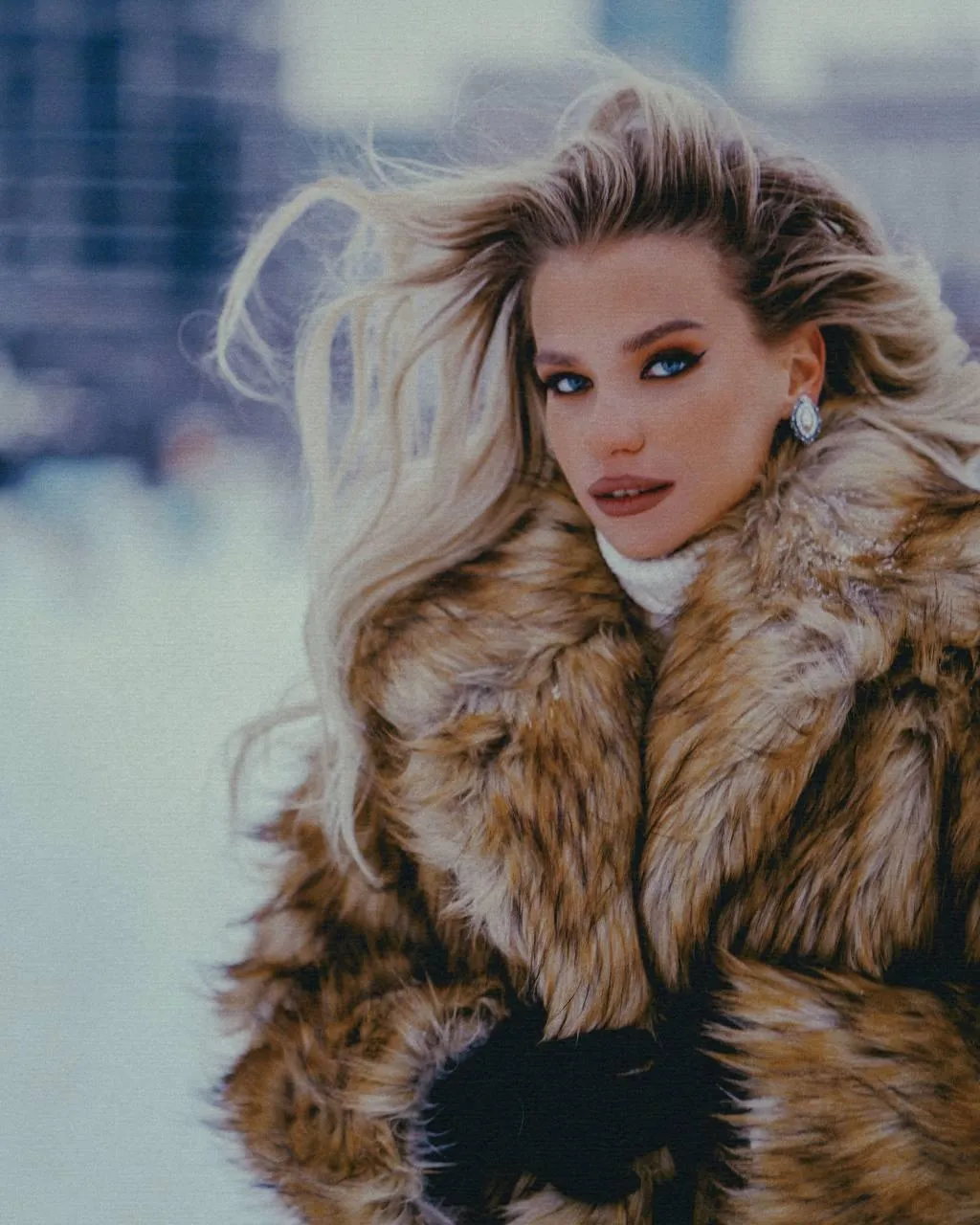 Woman in Fur Coat Standing Outdoors with a Windy Background