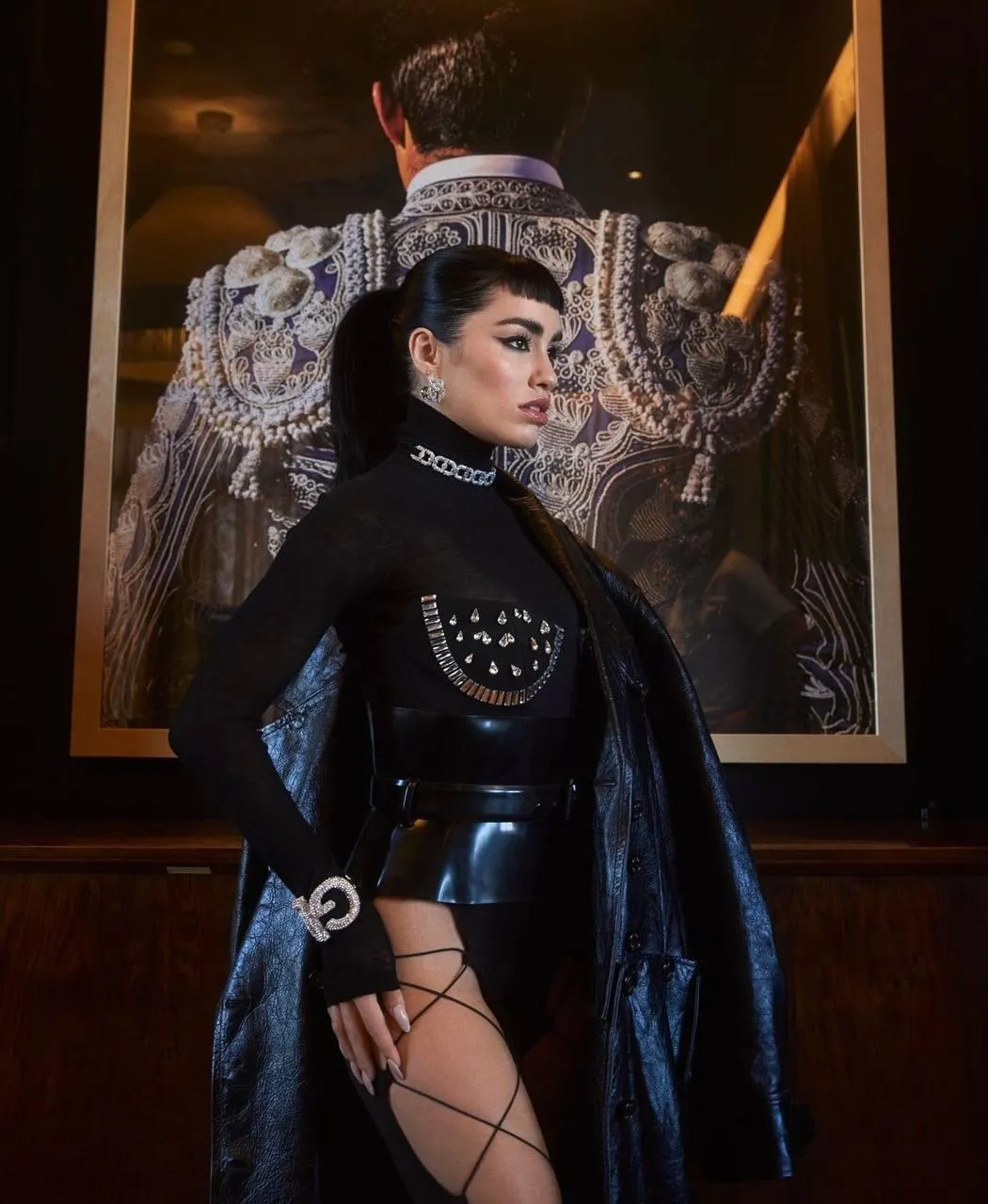 Woman in Futuristic Black Outfit with Dramatic Headpiece