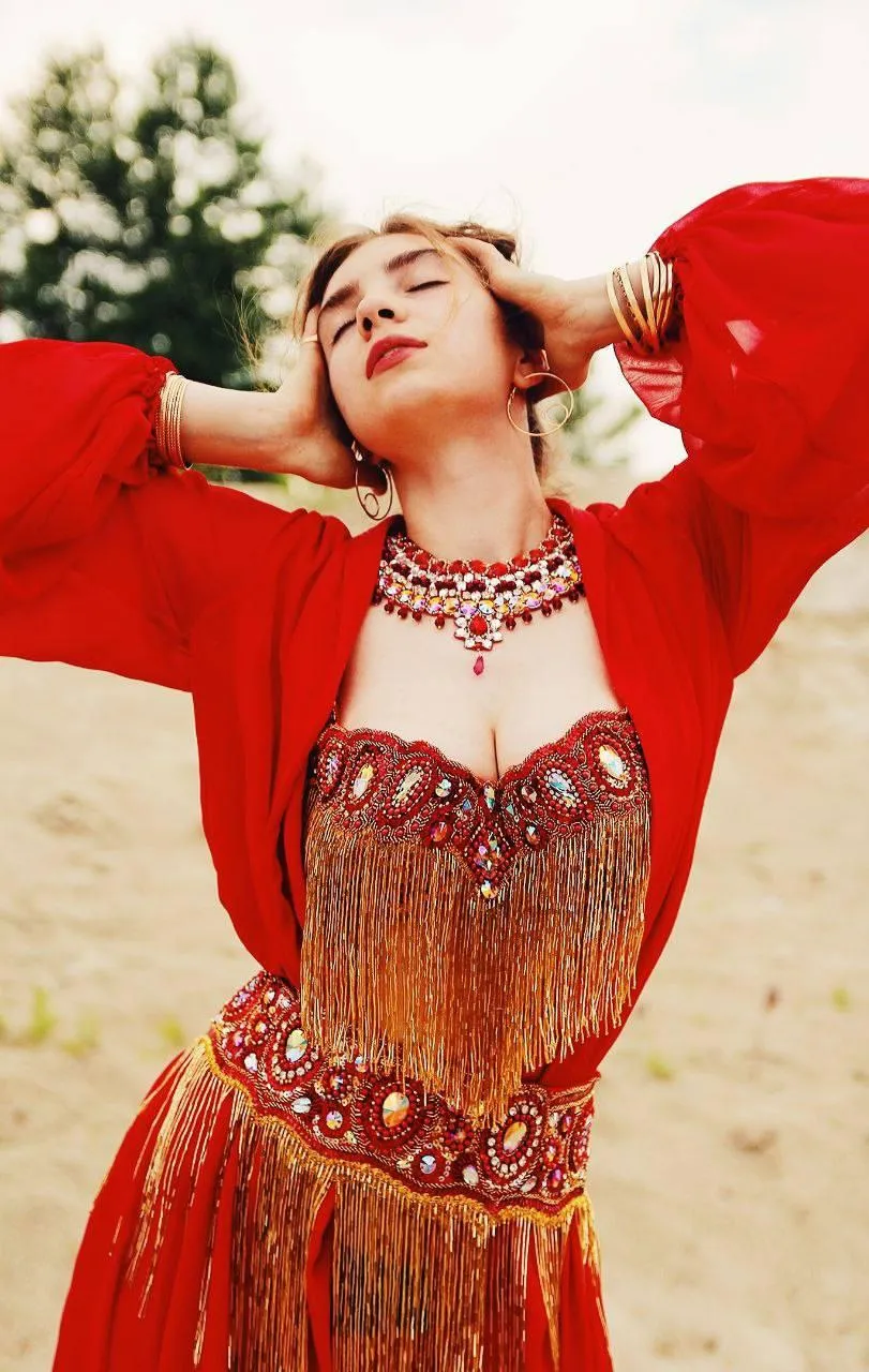 Woman in Red Outfit Stretching Her Arms Up in Sunny Outdoor