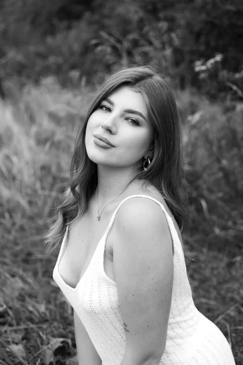 Woman in White Dress Looking Over Shoulder in Soft Daylight