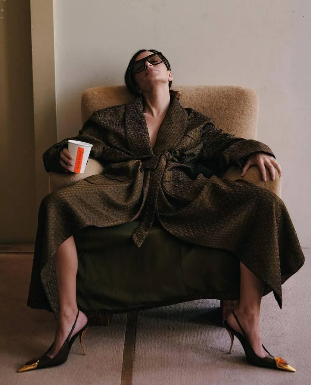Woman Lounging in a Robe with Coffee Cup on Tiled Floor