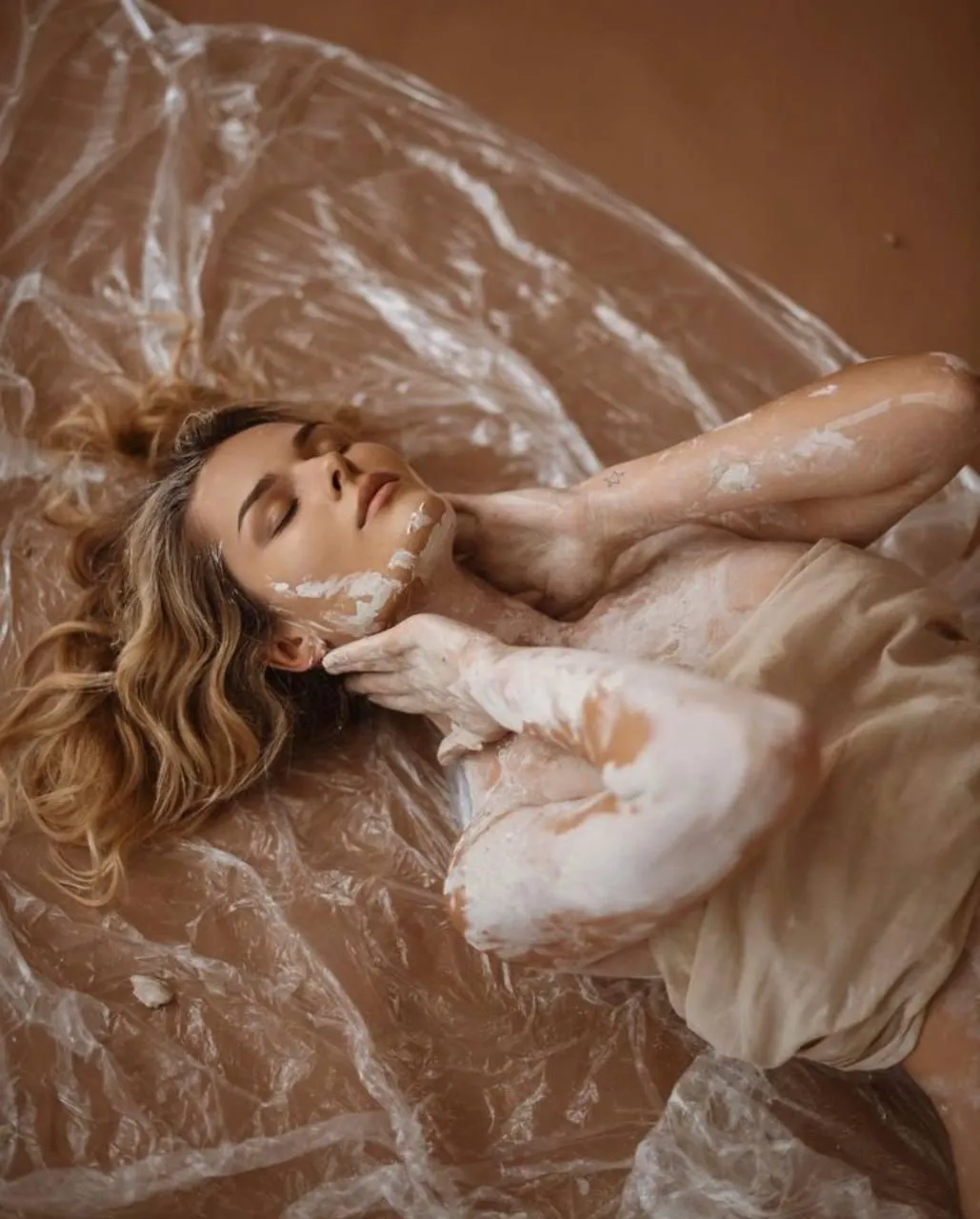 Woman Lying Down in a Silky Sheer Dress on Bronze Fabric