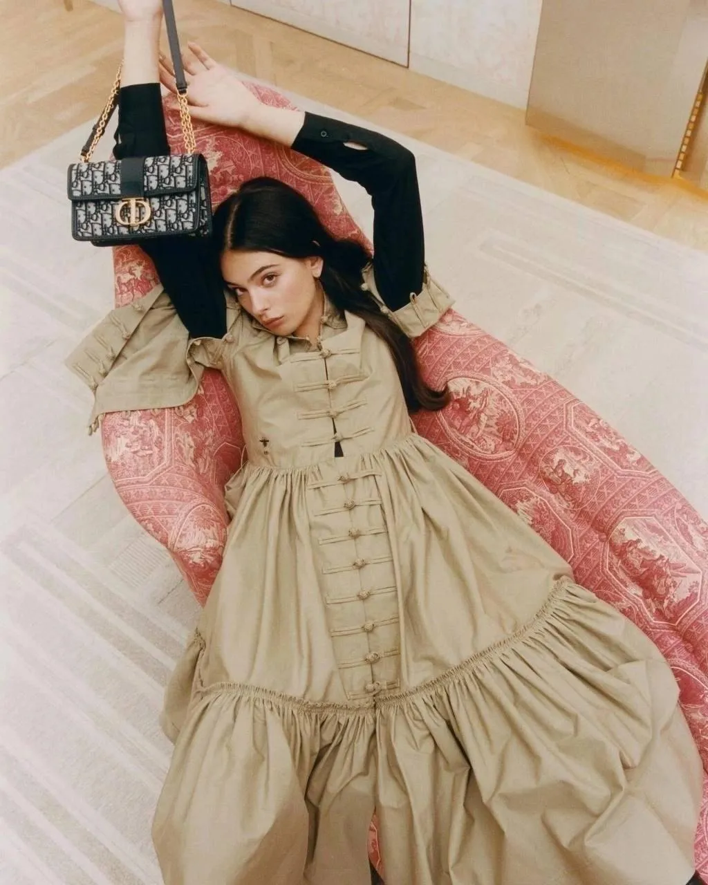 Woman Lying on a Pink Couch in a Vintage Cream Dress Image