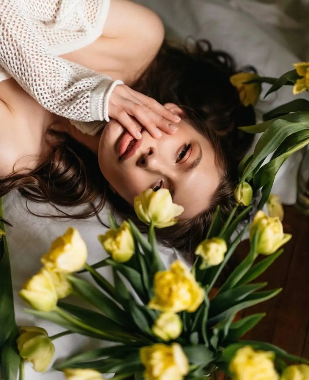 Woman Lying on a Yellow Flowers in a Soft Dreamy Pose Image