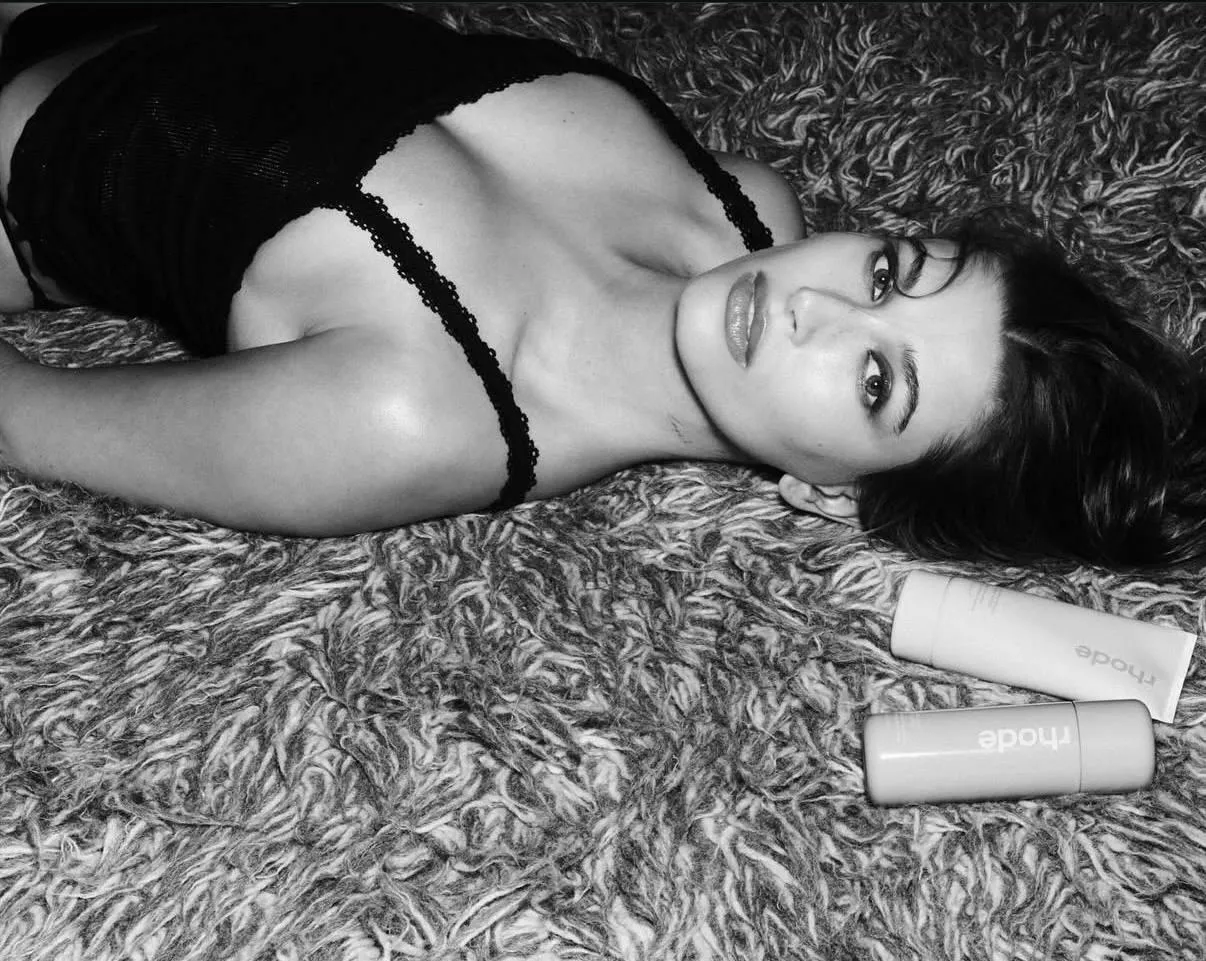 Woman Lying on Carpet in a Black Dress with Soft Expression
