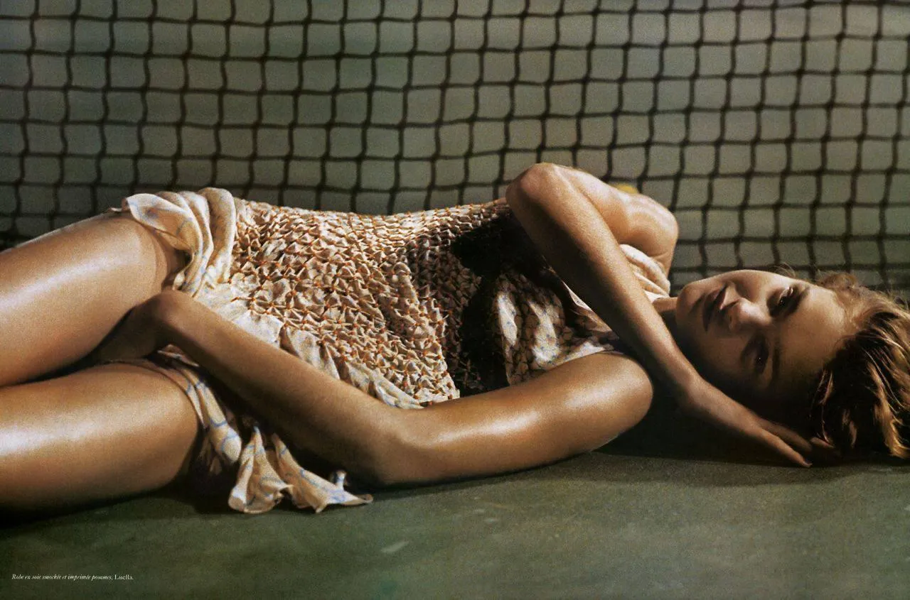 Woman Lying on the Ground in a Shiny Gold Sequin Dress Image