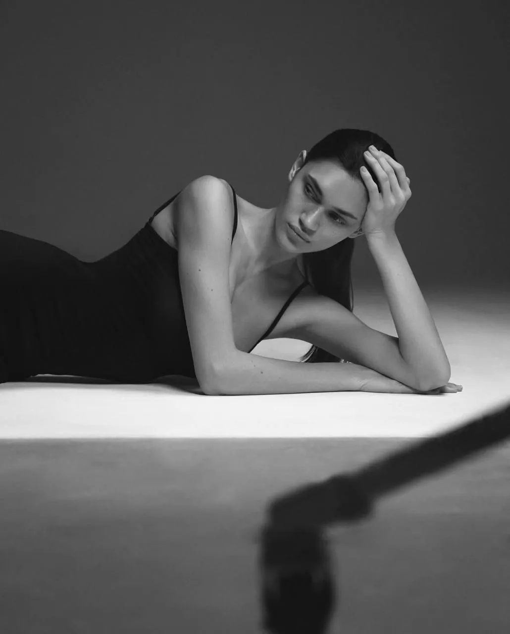 Woman lying on the studio floor with an artistic pose image