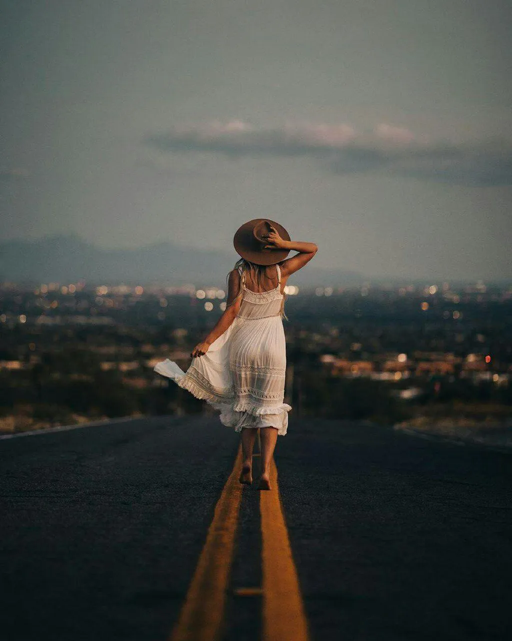 Woman on a Scenic Rooftop Gazing at the Distant City Skyline